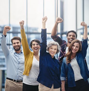 Cropped portrait of a group of businesspeople celebrating their success.